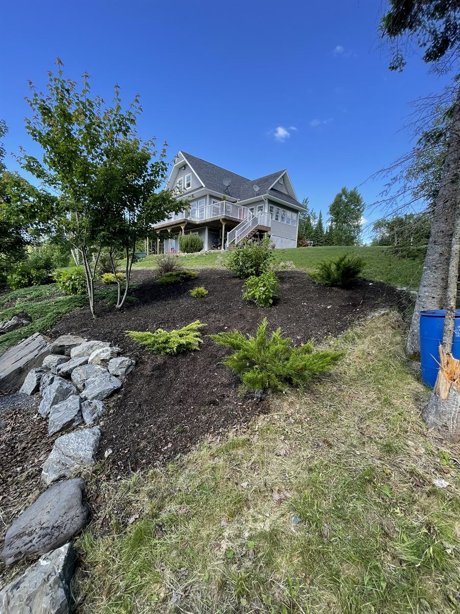 Fresh mulch and plantings after Hanson Lawn Care flower bed installation